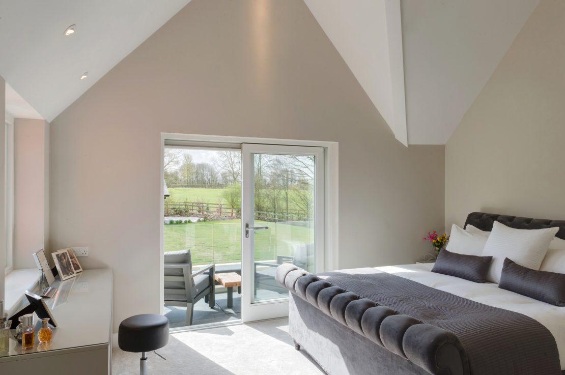 master bedroom with balcony and white sliding patio doors