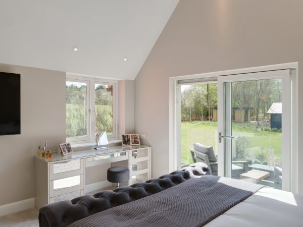 inside master bedroom with white sliding patio doors