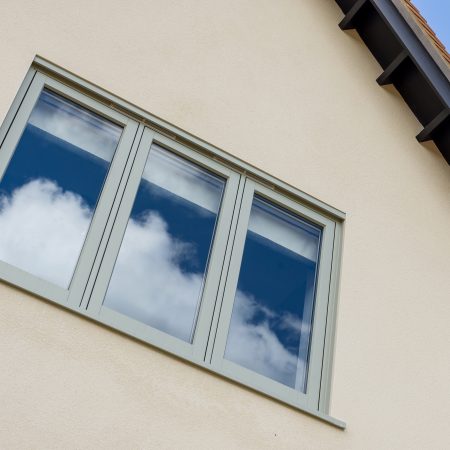 pale green casement windows on side of house