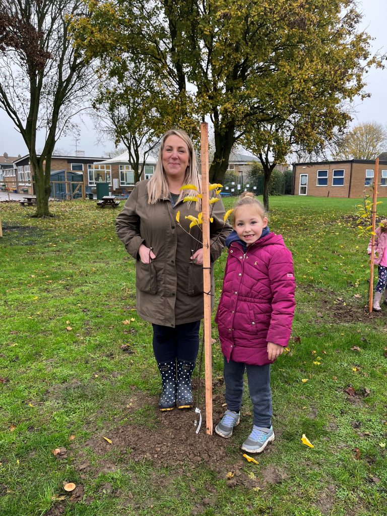 George Barnsdale staff member with a freshly planted tree