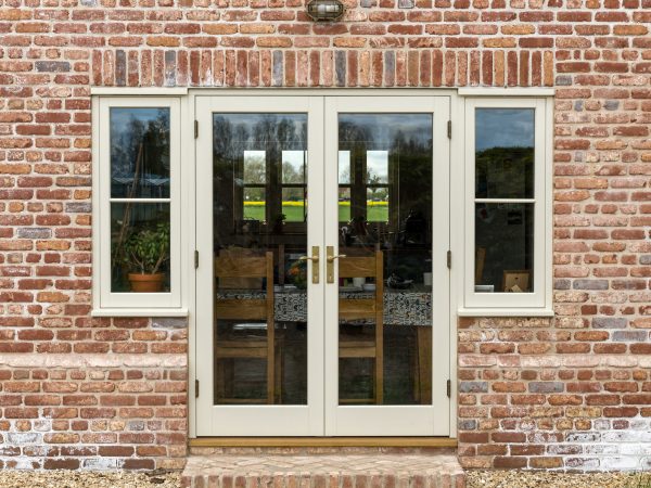 set of cream timber french doors with windows either side in a traditional new build in lincolnshire