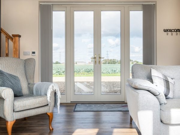 french doors in living room with views across Lincolnshire countryside.