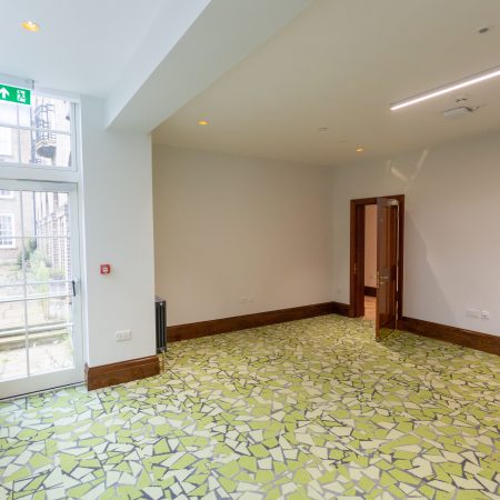 Fire escape door in glass and timber with astragal bars at Florence Boot hall