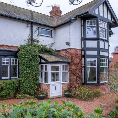 Arts & Crafts style house with George Barnsdale white and black sliding sash windows.