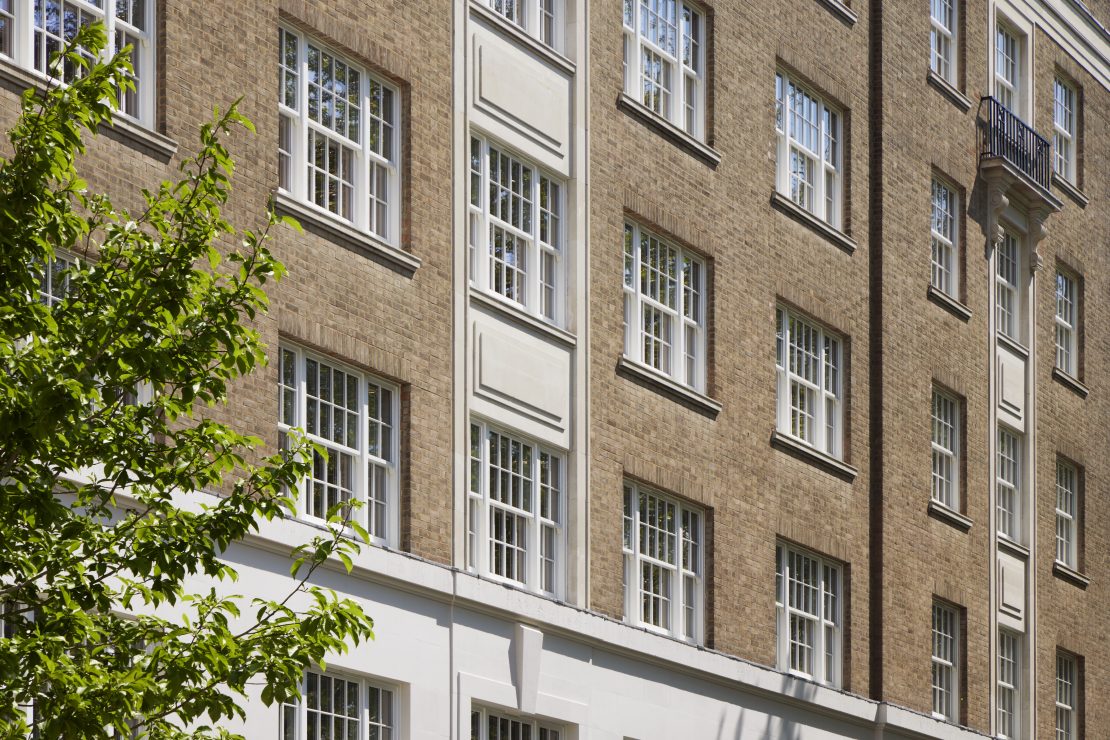 selection of timber sliding sash windows at 20 Berkeley Square, London. Painted in white. Art deco building