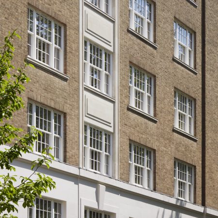 selection of timber sliding sash windows at 20 Berkeley Square, London. Painted in white. Art deco building