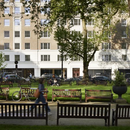 front facade of twenty Berkeley Sq from a distance with trees and grassed seating area in front. George Barnsdale timber sliding sash windows