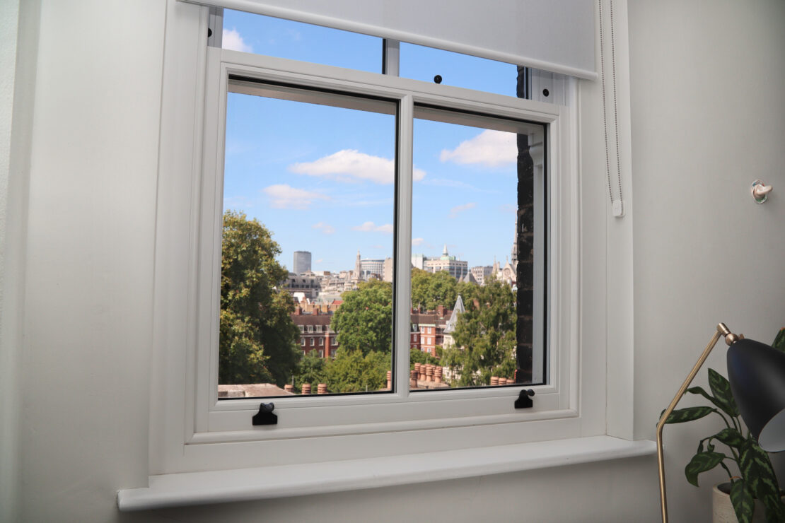 timber sliding sash window with a view across the city of London